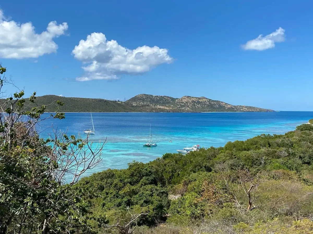 View from the Culebrita lighthouse trail over the anchorage and reef toward Culebra island