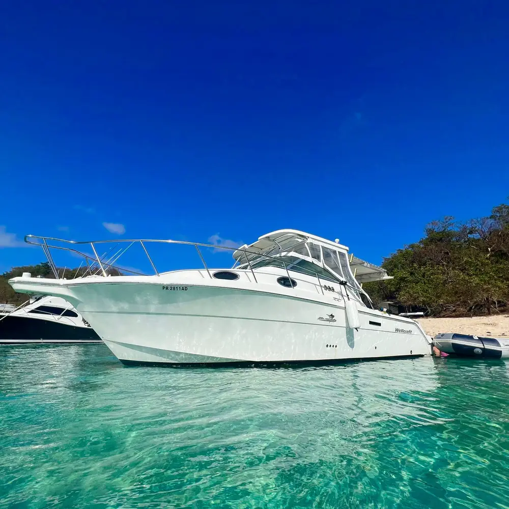 White Wellcraft motor yacht cruising on blue water off Fajardo, Puerto Rico - best-value private yacht rental