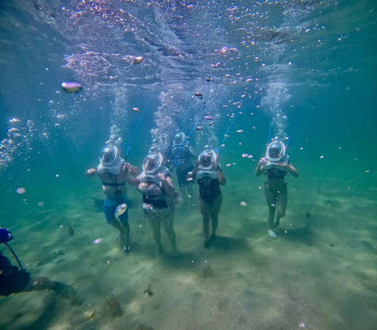 Helmet divers following a guide across the reef floor in San Juan