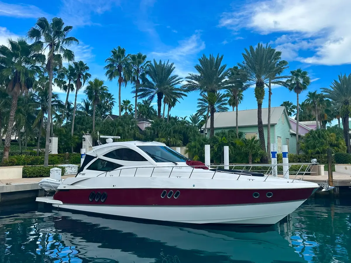 54-foot luxury cruiser yacht docked between palm trees in Puerto Rico - premium private yacht charter